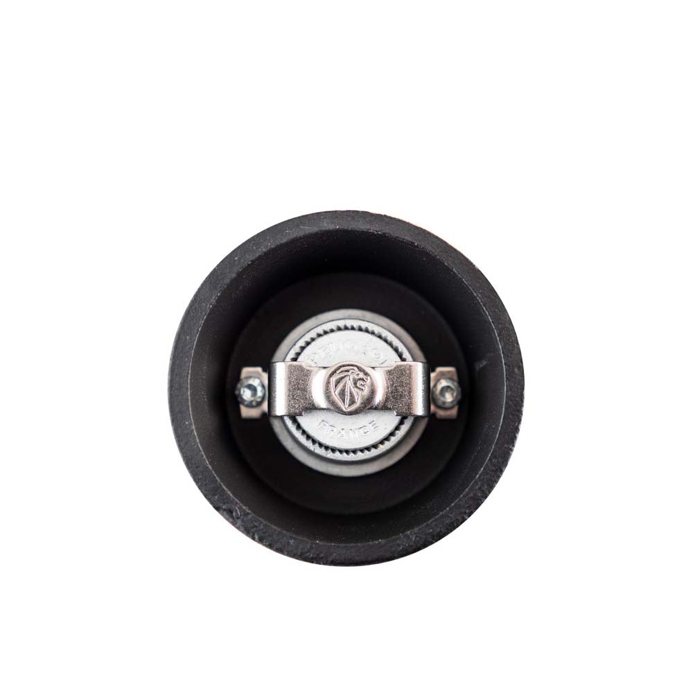 Close up of bottom of Peugeot Bali Fonte black cast iron pepper mill on a white background