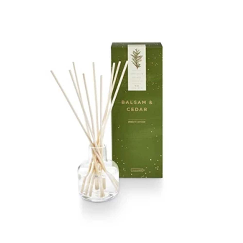 Illume brand balsam and cedar diffuser on a white background