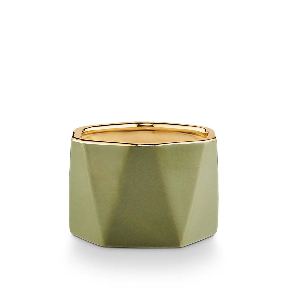 Illume 'Dylan' green ceramic balsam and cedar scented candle on white background 