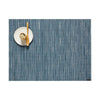 Chilewich Bamboo Signature Rectangle Placemat in rain blue color on a white background with a small plate and wood spoon