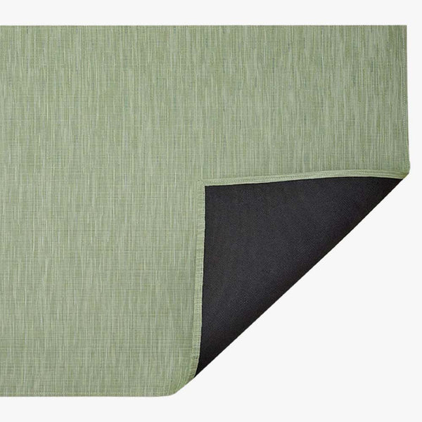 Chilewich bamboo woven floor mat in spring green on a white background