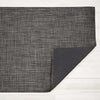 Chilewich basketweave woven floor mat in carbon on a light wood floor