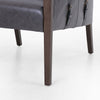 Four Hands Furniture brand Bauer chair in chaps ebony with stained wood legs and leather buckled straps on a white background