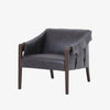 Four Hands Furniture brand Bauer chair in chaps ebony with stained wood legs and leather buckled straps on a white background