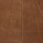 Four Hands Furniture brand Bauer chair in taupe leather with stained wood legs and leather buckled straps on a white background
