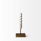 Side view of Mercana beaded broken sphere object in white with gold base on white background