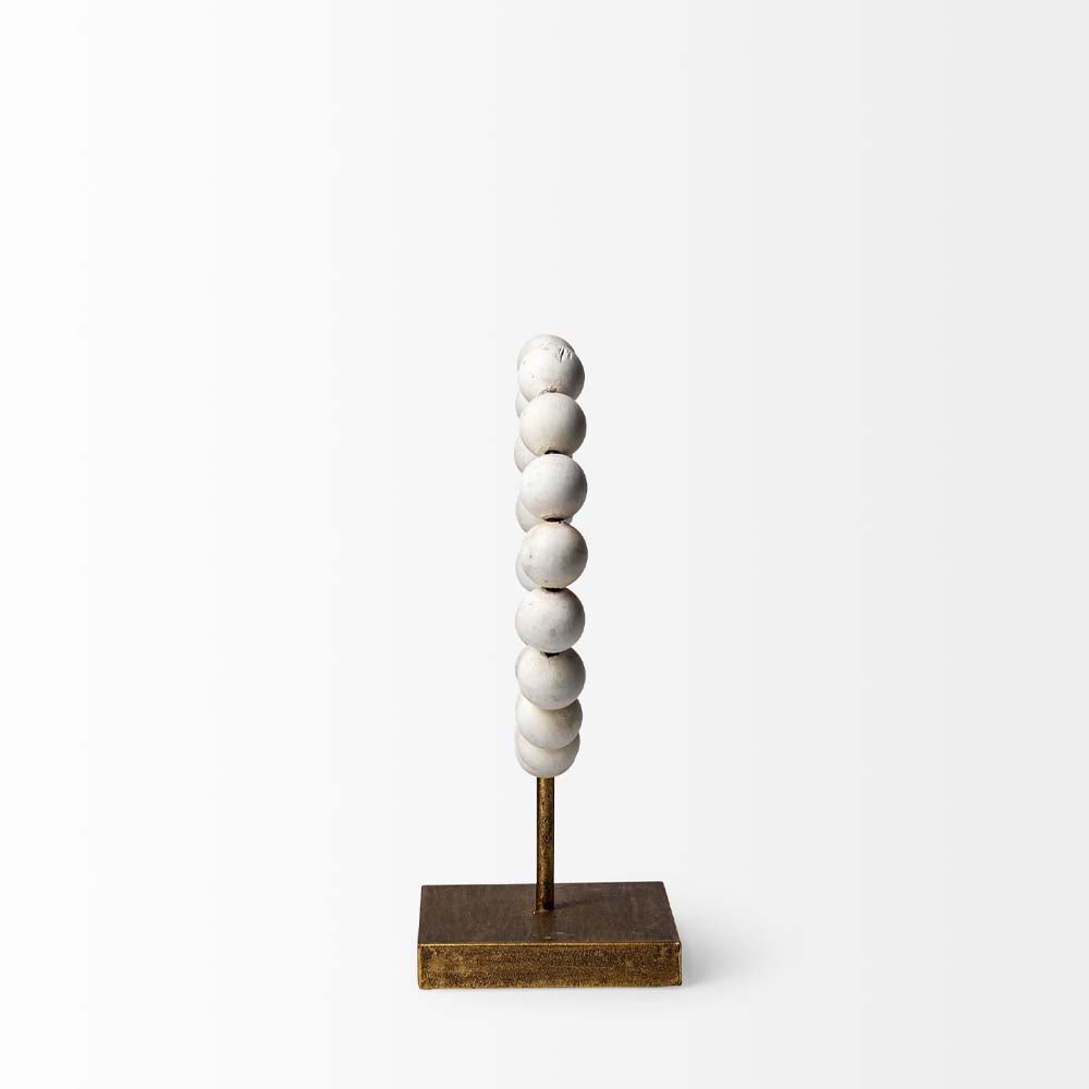 Side view of Mercana beaded broken sphere object in white with gold base on white background