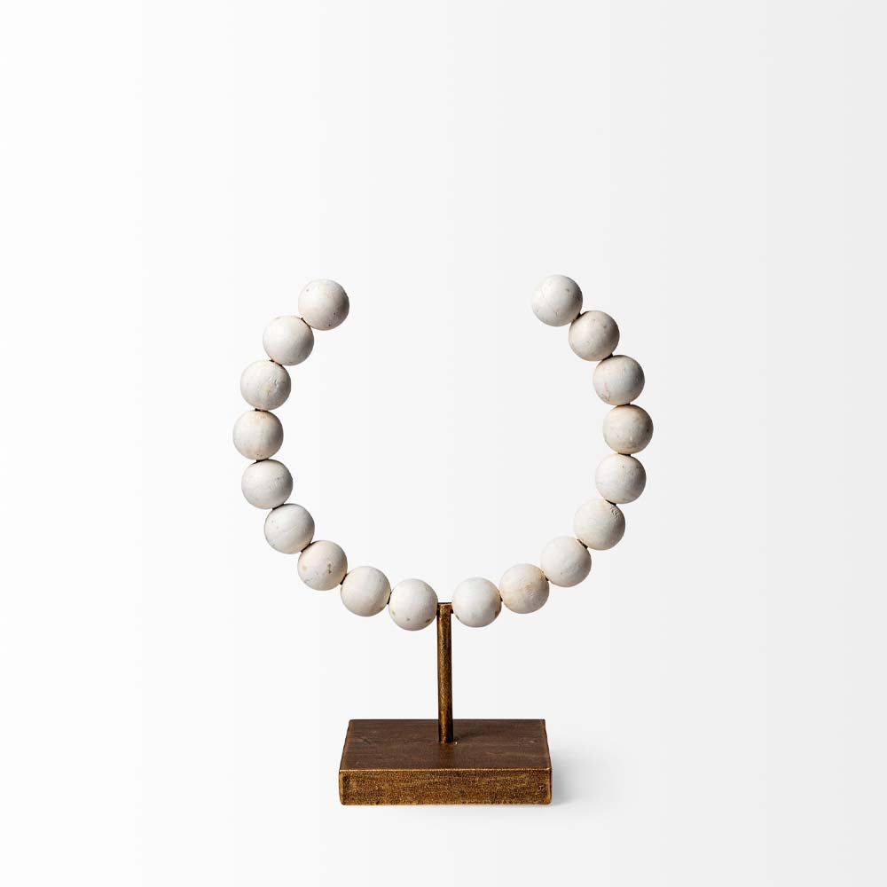 Mercana beaded broken sphere object in white with gold base on white background