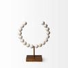 Mercana beaded broken sphere object in white with gold base on white background