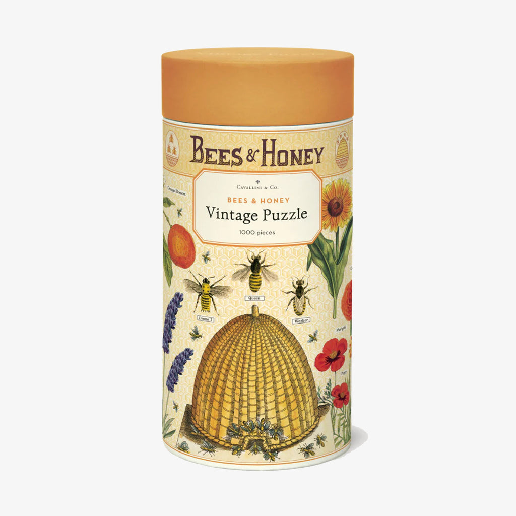 Yellow tube box holding 'bees and honey' puzzle by Cavallini paper company on a white background