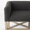 Grey upholstered accent bench with trellis wood base and small bolster back and nail head finish