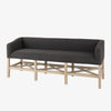 Grey upholstered accent bench with trellis wood base and small bolster back and nail head finish