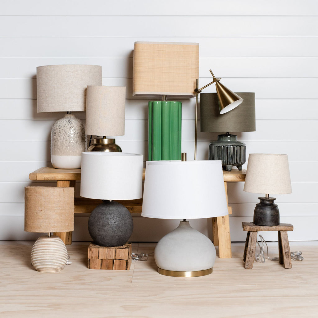 Collection of various lamps against a white wall 