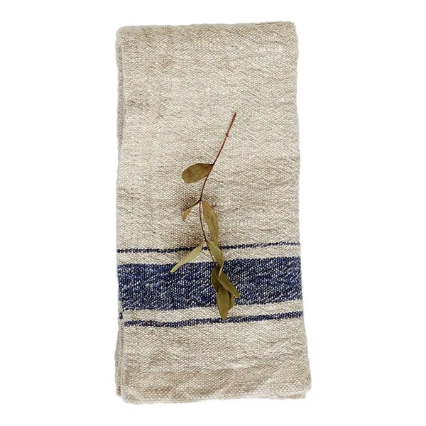 Natural linen napkin with blue stripe on a white background