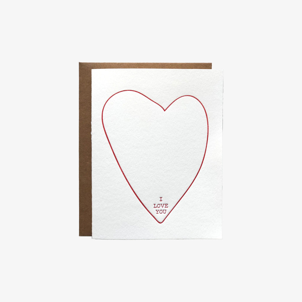 White greeting card with letter press hear and I love you written at bottom