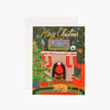 Rifle paper company Christmas Eve Greeting Card with fireplace and christmas tree and dog on rug on a white background