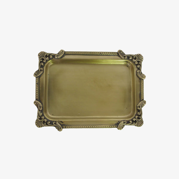 Small brass tray with victorian detailing on a white background