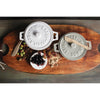 Wood board with two brie bakers in grey and white on a countertop