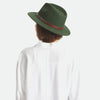 Back view of Brixton brand Messer fedora hat in moss green on model with white shirt and jeans a white background