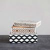 Two boxes with inlay of brown and white and black and white stacked on top of each other 