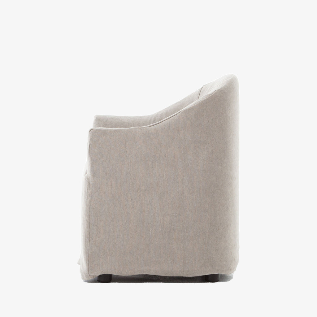 Side view of Four hands furniture brand cove dining chair with linen slip cover on a white background
