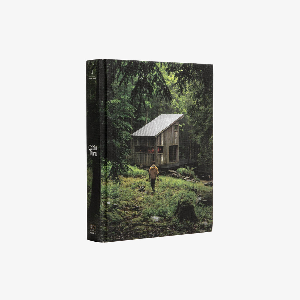 Front cover of book titled 'cabin porn' with woods and white and black letters