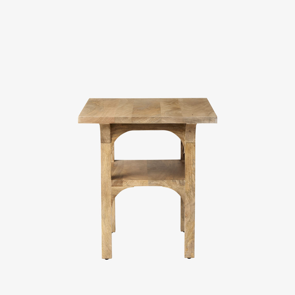 Light wood accent table with arched base and shelf detail on a white background