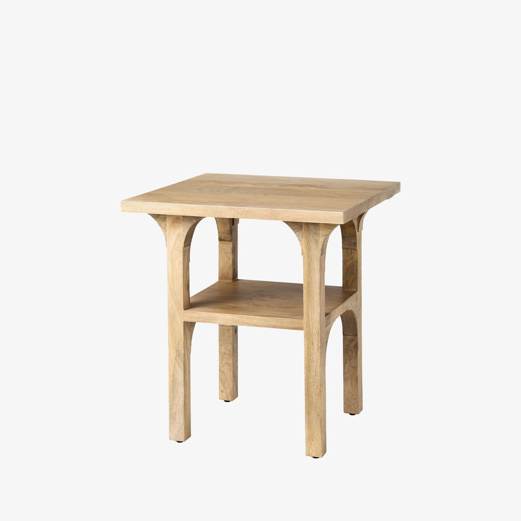 Light wood accent table with arched base and shelf detail on a white background
