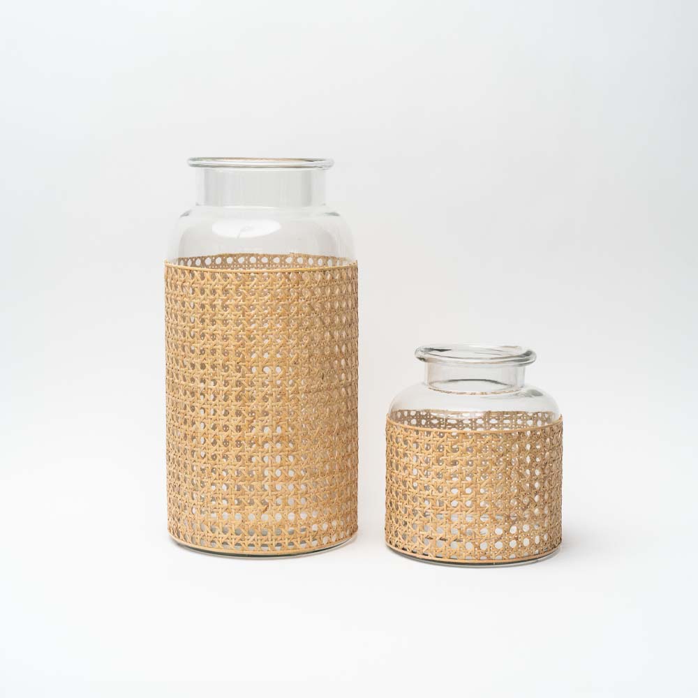 Two cane wrapped glass vases on a white background