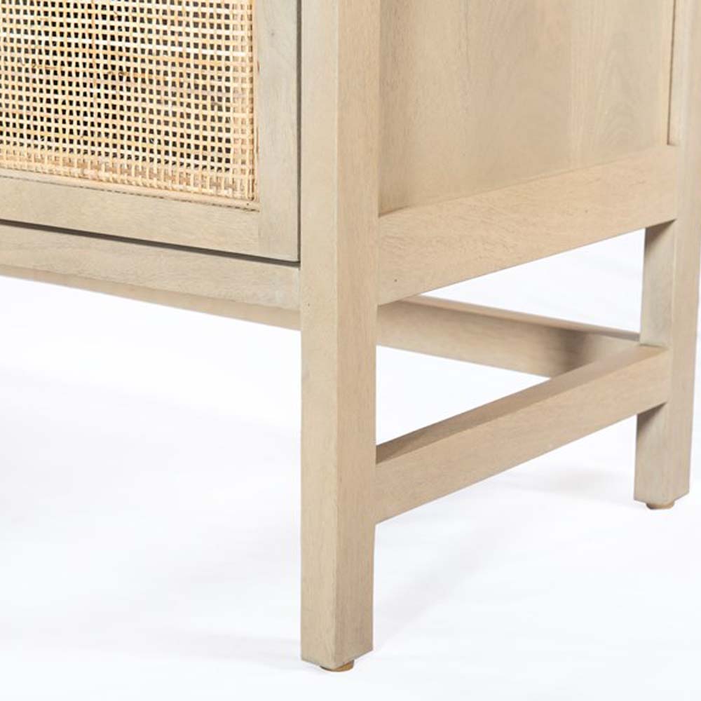 Close up of legs on Four Hands Furniture brand caprice sideboard in light wood with four cane doors and iron handles