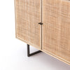Close up of doors on Four Hands furniture brand Carmel side board with four cane doors on a white background