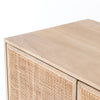Close up of finish on Four Hands furniture brand Carmel side board with four cane doors on a white background