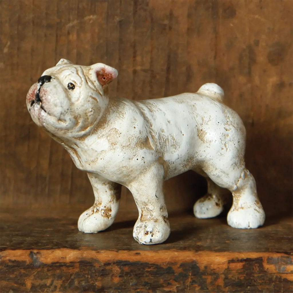 Cast iron white french bulldog on a wooden shelf