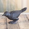 Cast iron bird on a wood surface