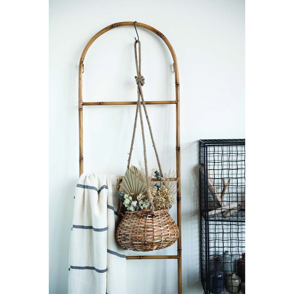 Hand-Woven Hanging Rattan Basket on a display.