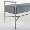 Bench with metal frame and grey upholstered seat on a white background