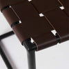 Close up of Brown Leather Woven Seat With Black Metal Frame Stool on a white background