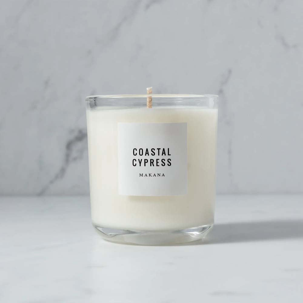 Makana brand coastal cypress glass candle on marble counter 