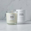 Makana brand coastal cypress candle and white candle box on marble counter 