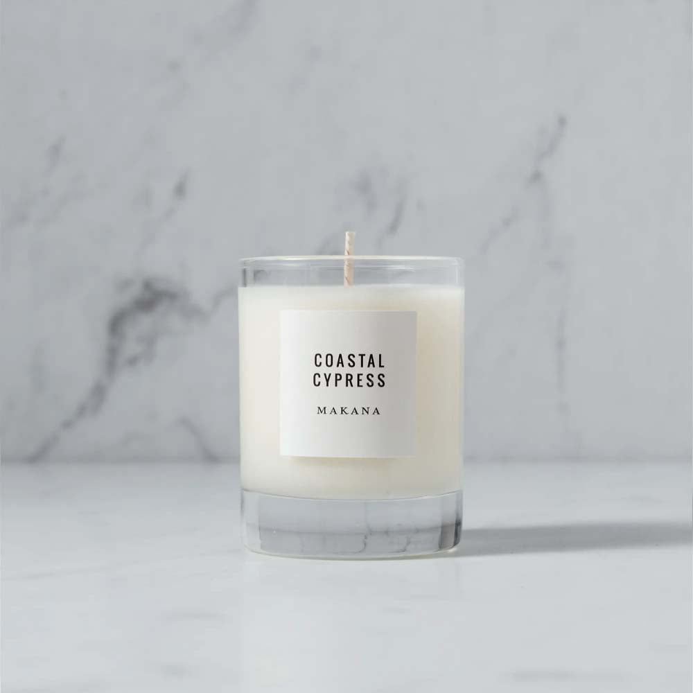 Makana brand coastal cypress glass candle on a marble counter
