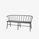 Black metal bench with Windsor chair styling and curves back rail on a white background