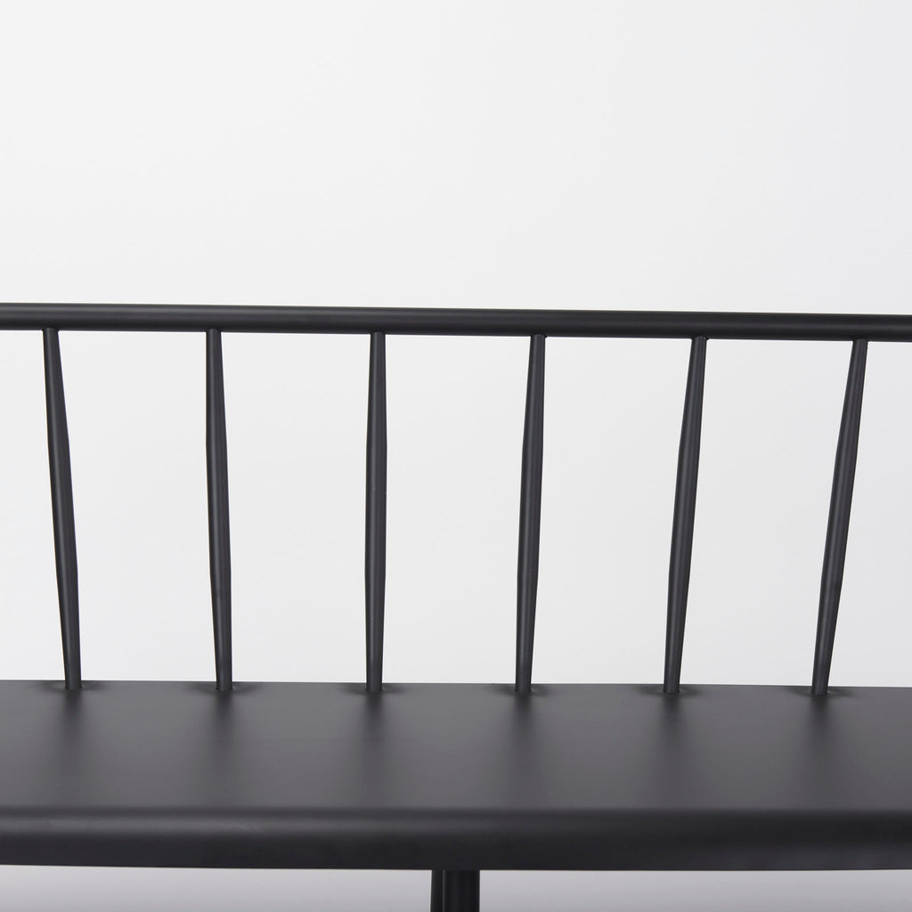 Close up of Black metal bench with Windsor chair styling and curves back rail on a white background