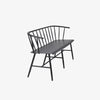 Side view of Black metal bench with Windsor chair styling and curves back rail on a white background