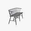 Side view of Black metal bench with Windsor chair styling and curves back rail on a white background