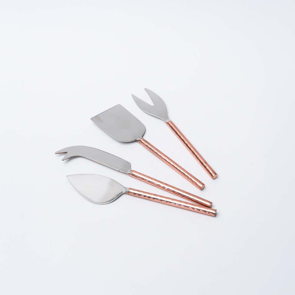 Set of four copper cheese servers on a white background