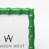 Close up of green picture frame with bamboo wood style edge on a white background