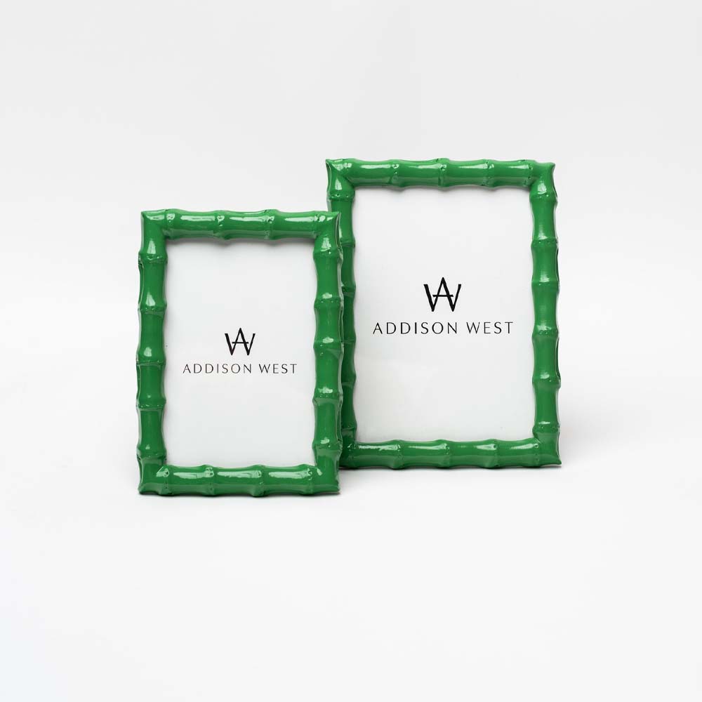 Two green picture frames with bamboo wood style edge on a white background