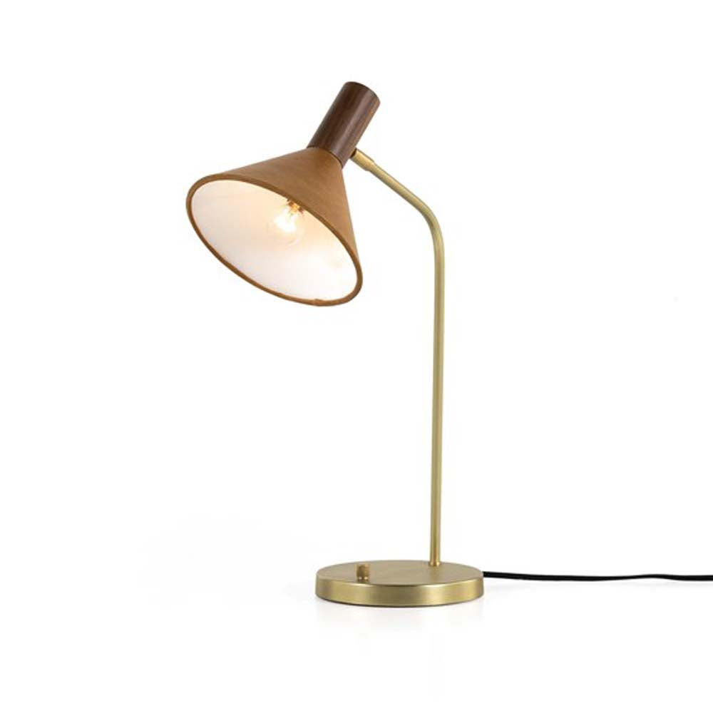 Four hands brand Cullen task lamp in brass with leather shade and walnut accents with bulb lit on a white background