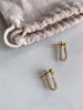 Able brand Curb Chain earrings in 14 carat gold fill on a grey background