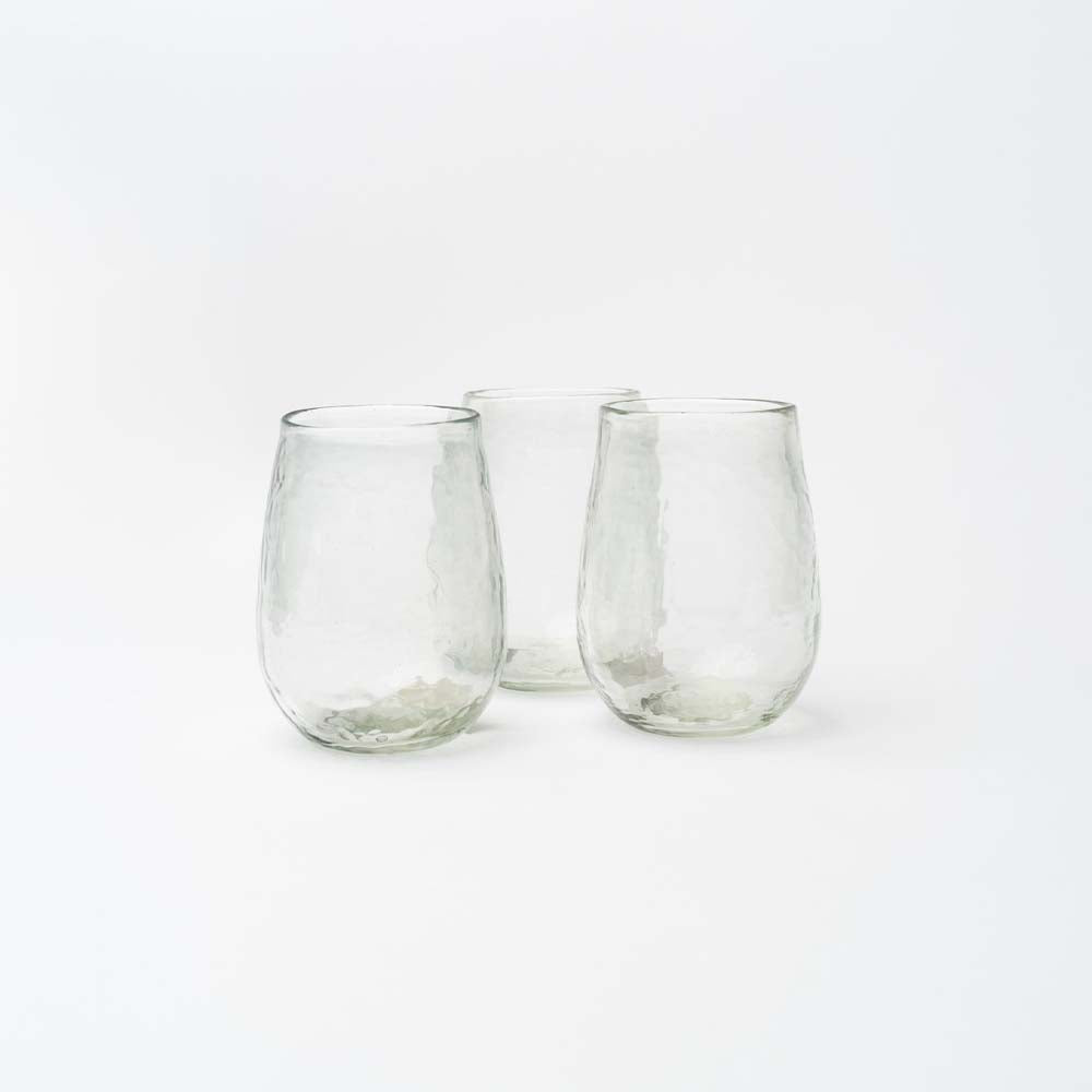 set of three stemless wine glasses on a white background.